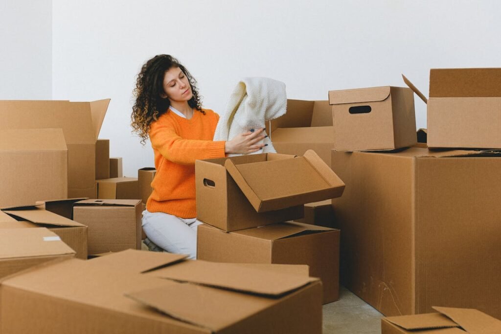 Professional senior movers carefully packing household belongings into boxes as part of a comprehensive senior moving service in North Vancouver.